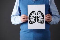 man holding image of lungs