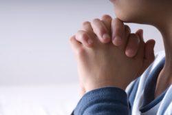 Praying hands of young person