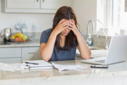 Stressed woman looking at bills