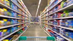 Supermarket shelves with shopping cart