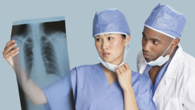 Surgeons looking at chest x-ray