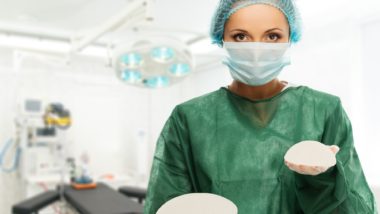 Plastic surgeon woman holding different size silicone breast implants