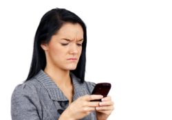 woman looking at text message on phone