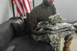 Soldier sitting on couch with uniforms
