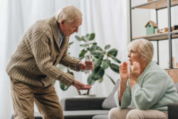Elderly husband offering wife medication