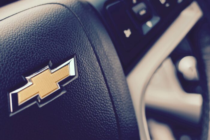 Close up of Chevrolet logo on a steering wheel - General Motors engine defect class action, dismiss