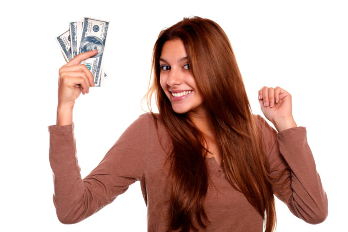woman holding money from settlement checks