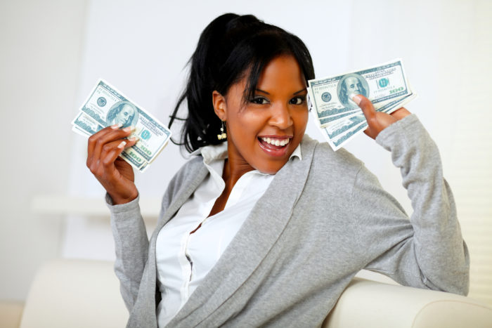 woman holding money from an FTC check