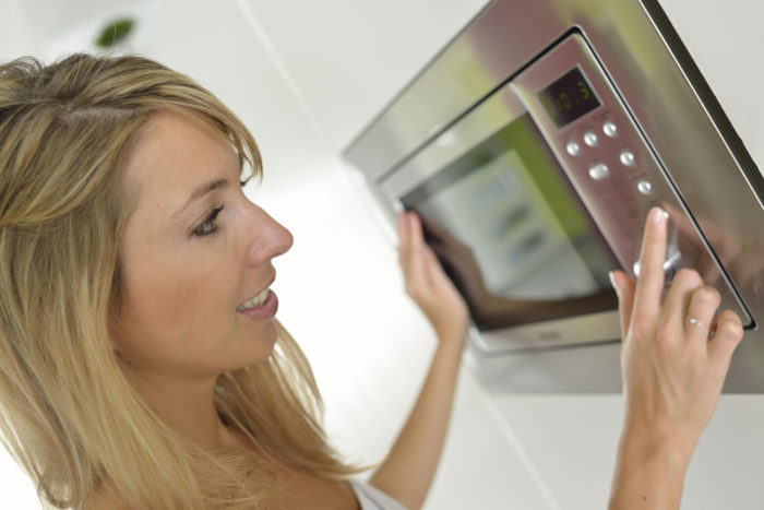 woman using Sharp microwave oven drawer