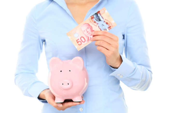 woman holding canadian currency from class action rebates