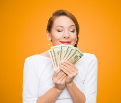 woman holding class action rebates money