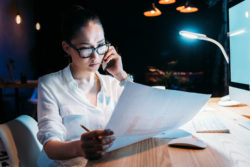 A woman works late in an office.