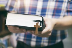 Man with bible, cross