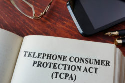 Book with TCPA on wood desk