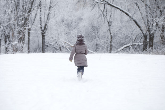 child walking in snow in Canada