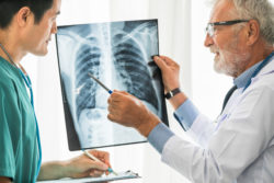 Two doctors discuss a chest X-ray.