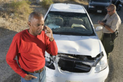 A man makes a call after a car crash.