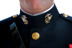 A Marine wears emblems on his collar.
