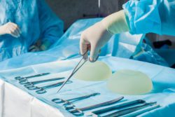 nurse assisting surgeon in breast implant surgery