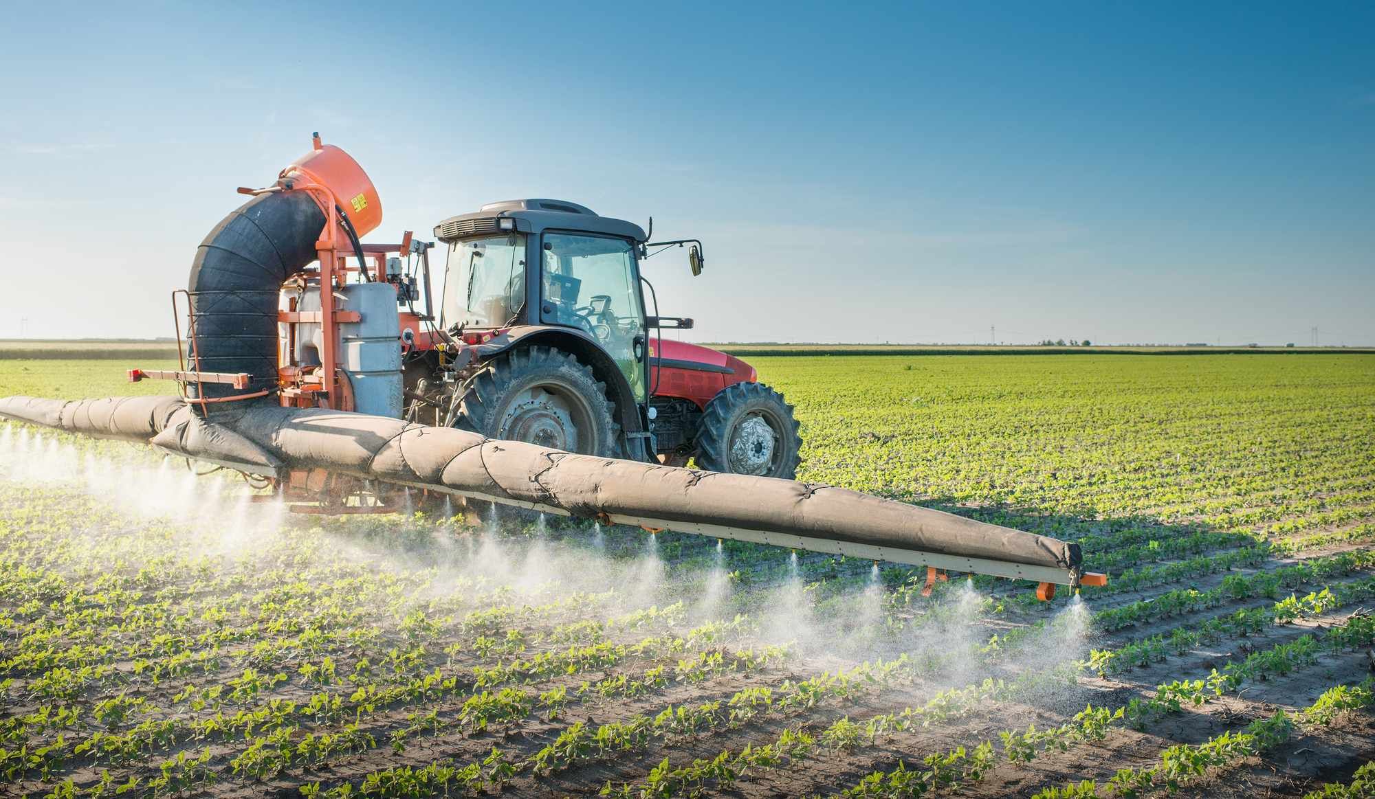 Tractor spraying crops