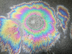A gasoline spill appears in rainbow colors.