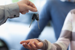 car dealer handing over keys
