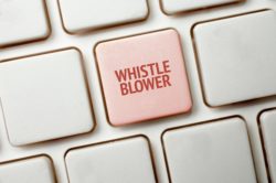 Red whistleblower key on keyboard
