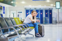 A girl waits in an airport.