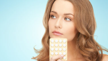 woman holding loestrin birth control pills