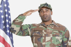 American Marine soldier salutes U.S. flag.