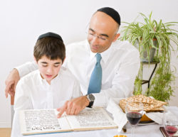 Jewish man reading with boy regarding an ex-hasidic couple suing Quebec government over inadequate education