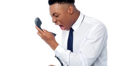 angry african american man dealing with robocalls