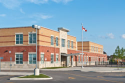 school with the Canadian flag regarding the excluded day school survivors' class action