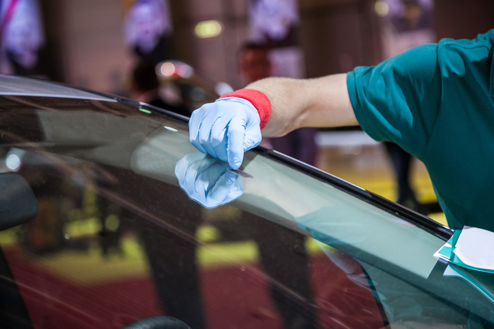 person repairing windshield glass
