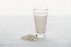 Glass of milk with rice next to it