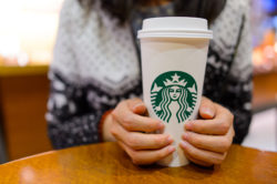Woman holding vent Starbucks drink
