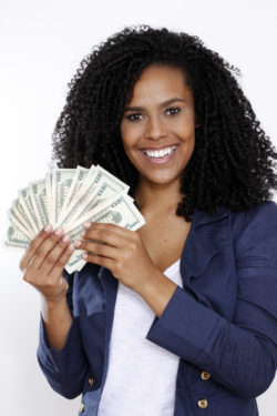 Woman holding money and smiling