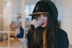 Young person vaping JUUL e-cigarette