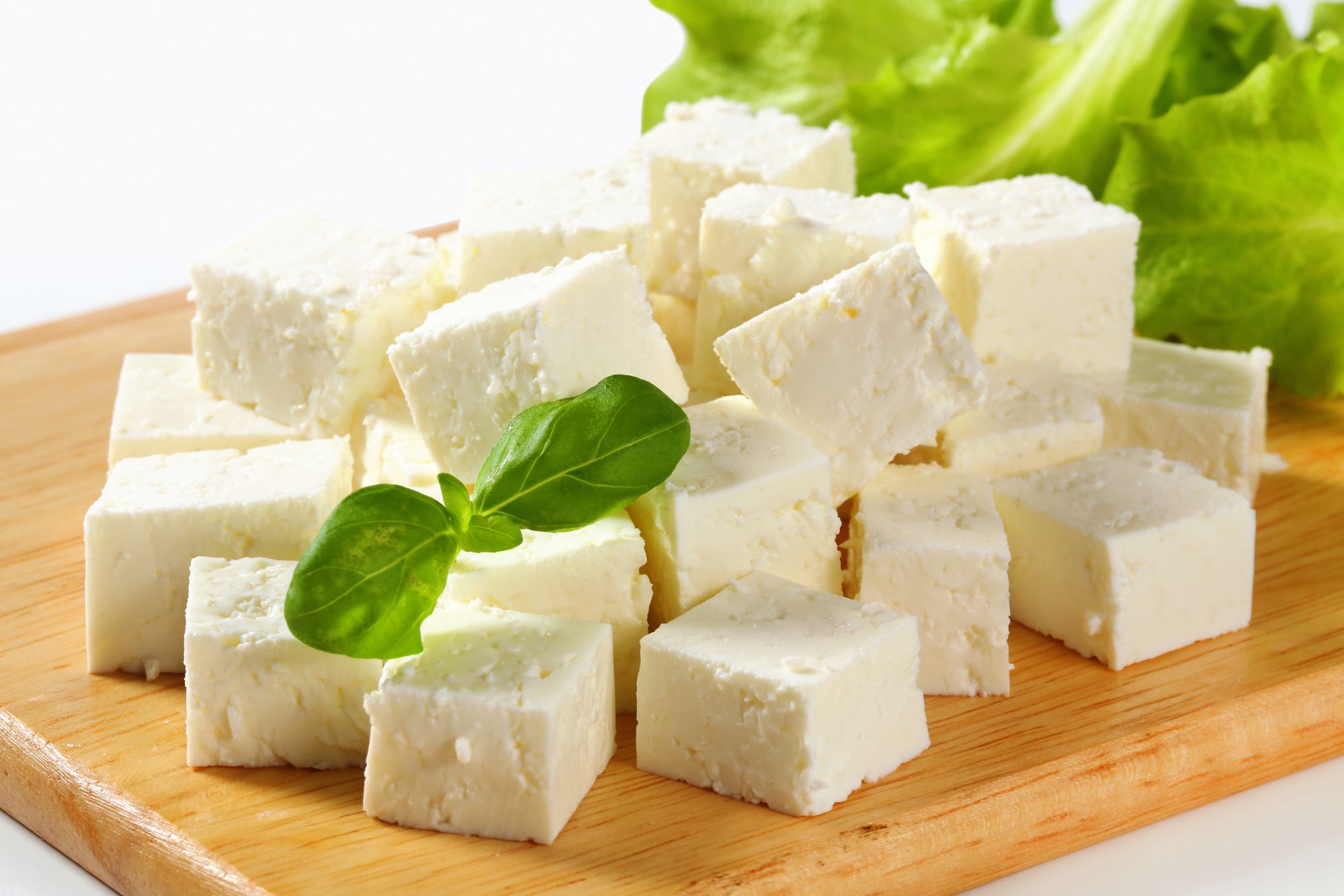 Feta Cheese cubes on cutting board regarding Glooscap lawsuit over cheese deal gone sour