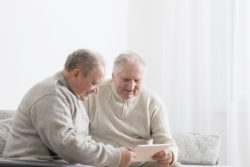 Elderly men look at job postings