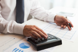 Tax accountant working with calculator