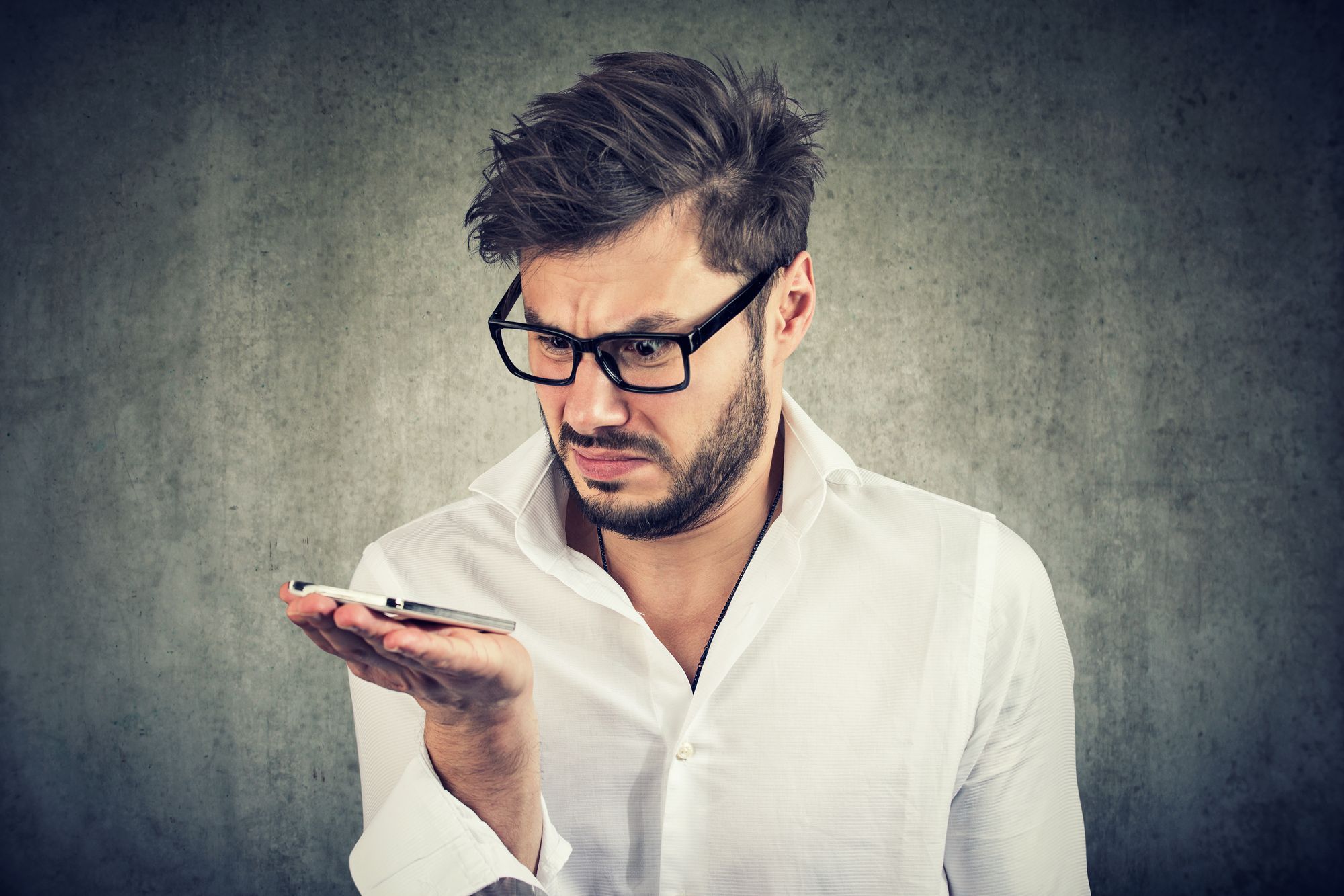 man looking at unwanted texts on phone