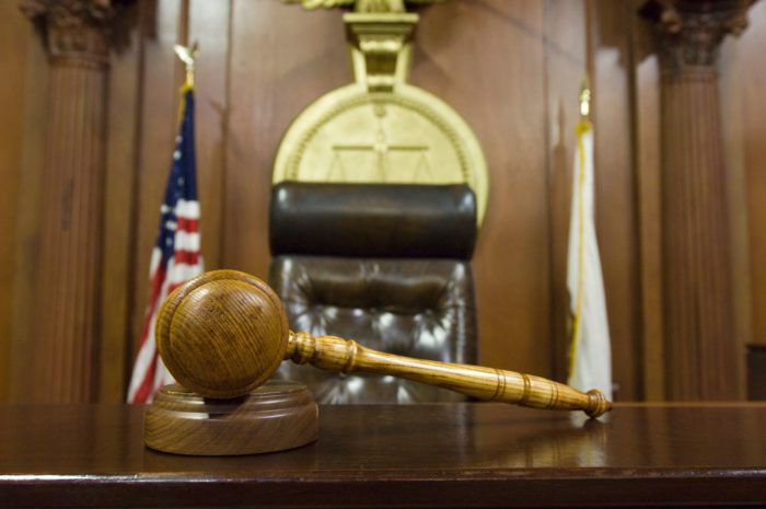 a gravel sits on top of judge's bench in courtroom