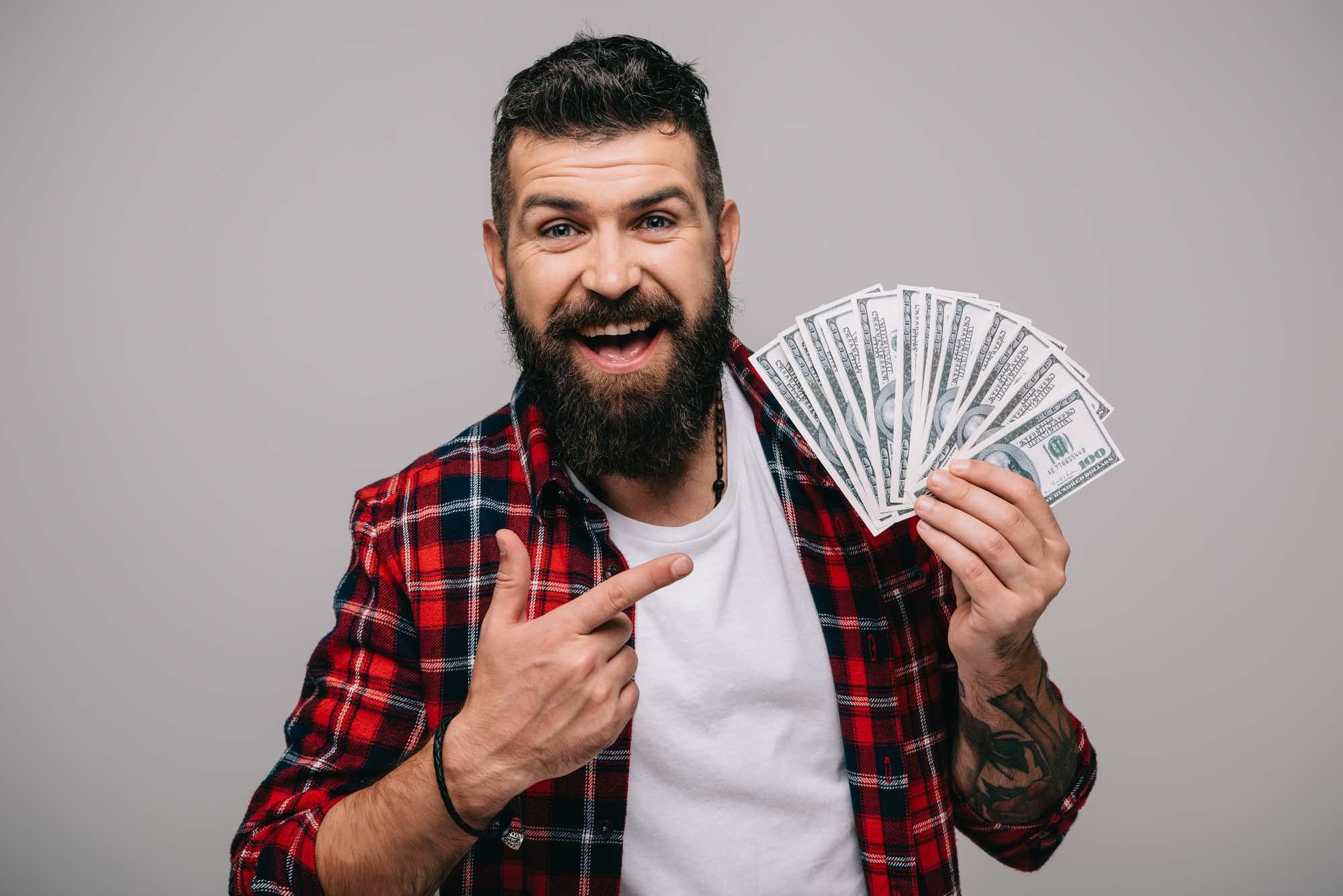 Happy man holding cash