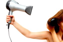 woman holding hair dryer