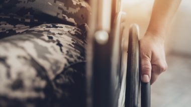 Lower half of a veteran in a wheelchair regarding the federal court ruling in favor of the injured veterans' disability benefits class action lawsuit