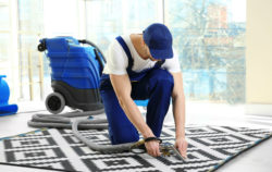 Man uses wet dry vacuum cleaner on floor