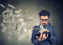 hipster with money flying out of wallet