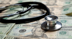 Stethoscope on money (hospital bills)