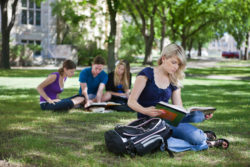 Students sit and read on a quad.